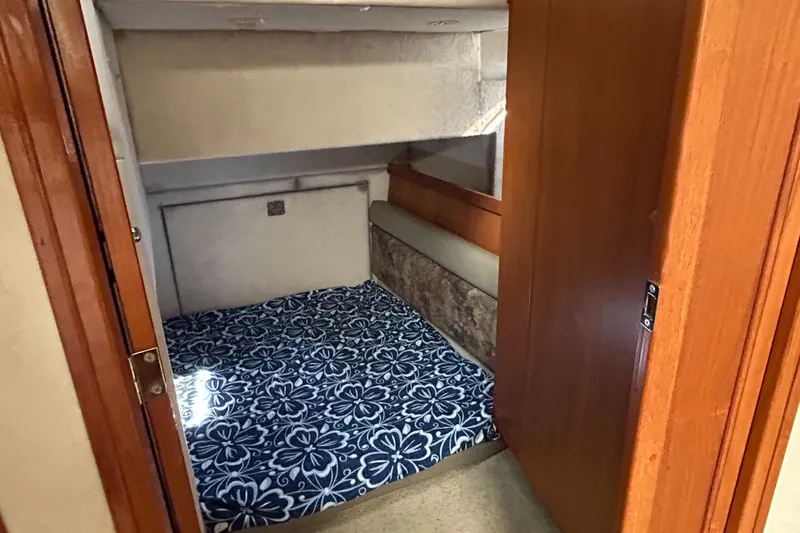 Slide: The Image of 1996 Bayliner 4087 Aft Cabin Motoryacht interior with cozy bed and wooden accents. - 15