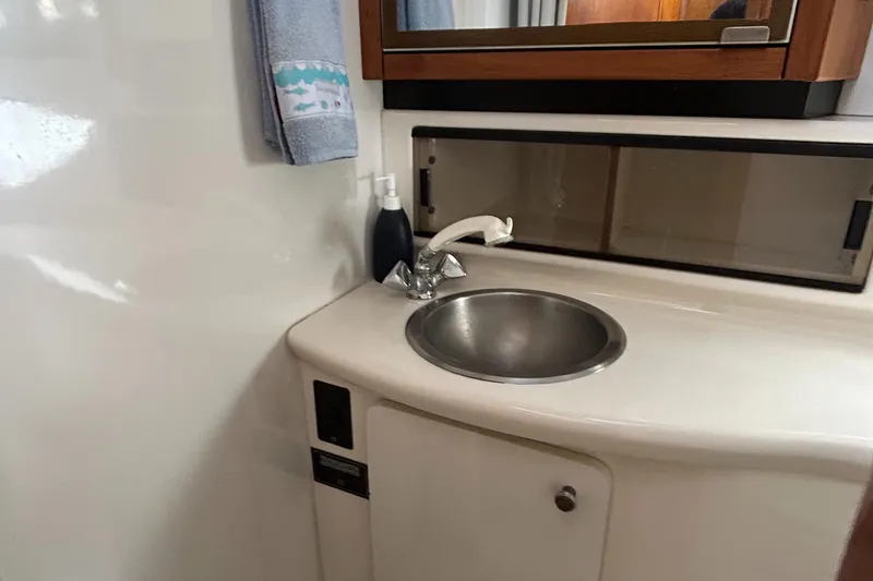 Slide: The Image of 1996 Bayliner 4087 yacht bathroom with sink, mirror, and towel. - 17