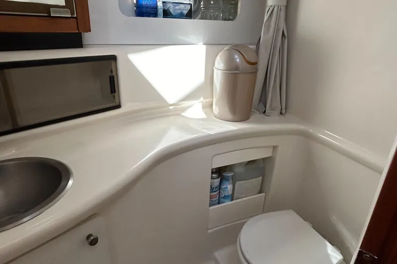 Slide: The Image of 1996 Bayliner 4087 Aft Cabin Motoryacht bathroom with sink, toilet, and storage. - 18