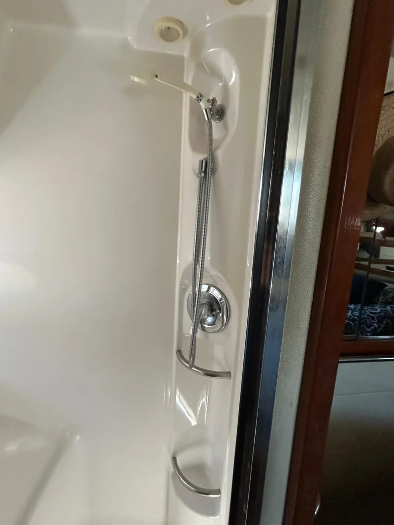 Slide: The Image of Shower area in 1996 Bayliner 4087 Aft Cabin Motoryacht, featuring chrome fixtures. - 19