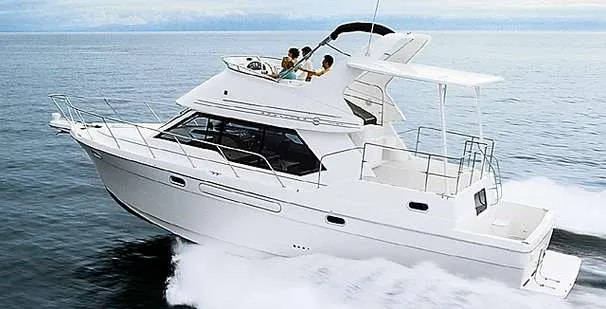 Slide: The Image of 1996 Bayliner 4087 Aft Cabin Motoryacht cruising on open water, side view. - 2
