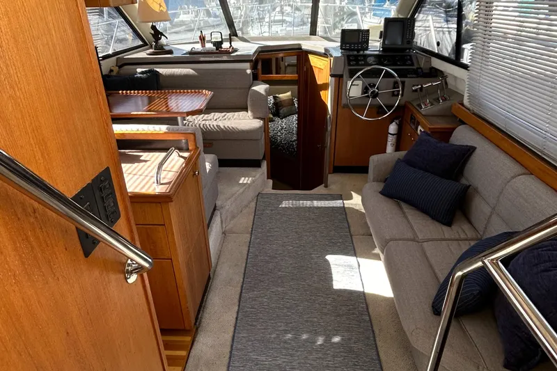 Slide: The Image of 1996 Bayliner 4087 Aft Cabin Motoryacht interior with seating, helm, and dining area. - 24