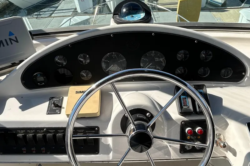 Slide: The Image of 1996 Bayliner 4087 Aft Cabin Motoryacht helm with steering wheel and instrument panel. - 30
