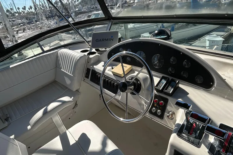 Slide: The Image of 1996 Bayliner 4087 Aft Cabin Motoryacht helm with Garmin navigation system and classic steering wheel. - 31
