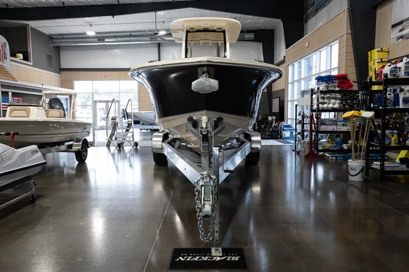 Slide: The Image of 2025 Scout 260 LXF boat displayed in a showroom with polished floors. - 10