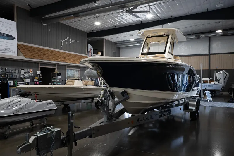 Slide: The Image of 2025 Scout 260 LXF boat displayed indoors on a trailer. - 11