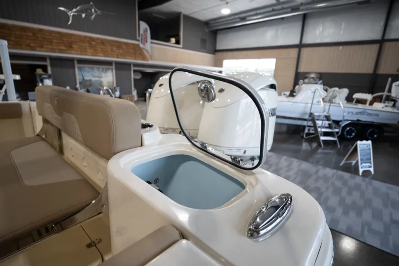 Slide: The Image of 2025 Scout 260 LXF boat interior with open storage compartment in showroom. - 15