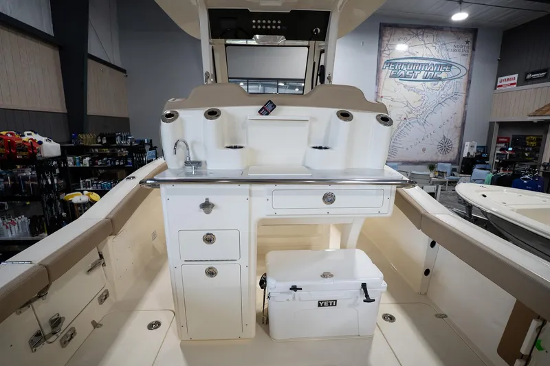 Slide: The Image of 2025 Scout 260 LXF boat interior with storage and Yeti cooler. - 16