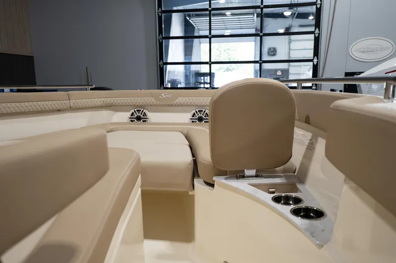 Slide: The Image of Interior view of 2025 Scout 260 LXF boat with beige seating and cup holders. - 26