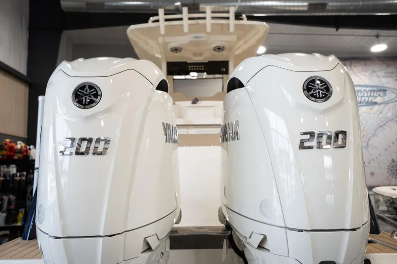 Slide: The Image of 2025 Scout 260 LXF with dual Yamaha 200 engines in showroom. - 29