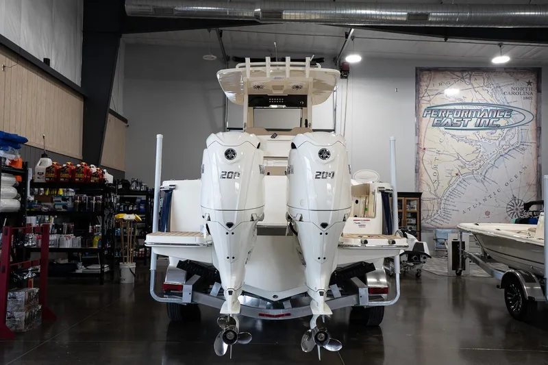 Slide: The Image of 2025 Scout 260 LXF boat with dual engines in a showroom setting. - 6