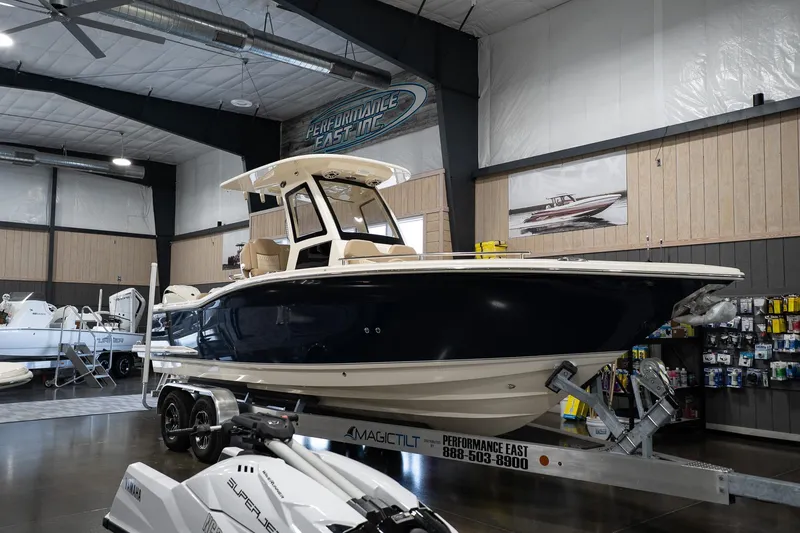 Slide: The Image of 2025 Scout 260 LXF boat displayed indoors on a trailer. - 7