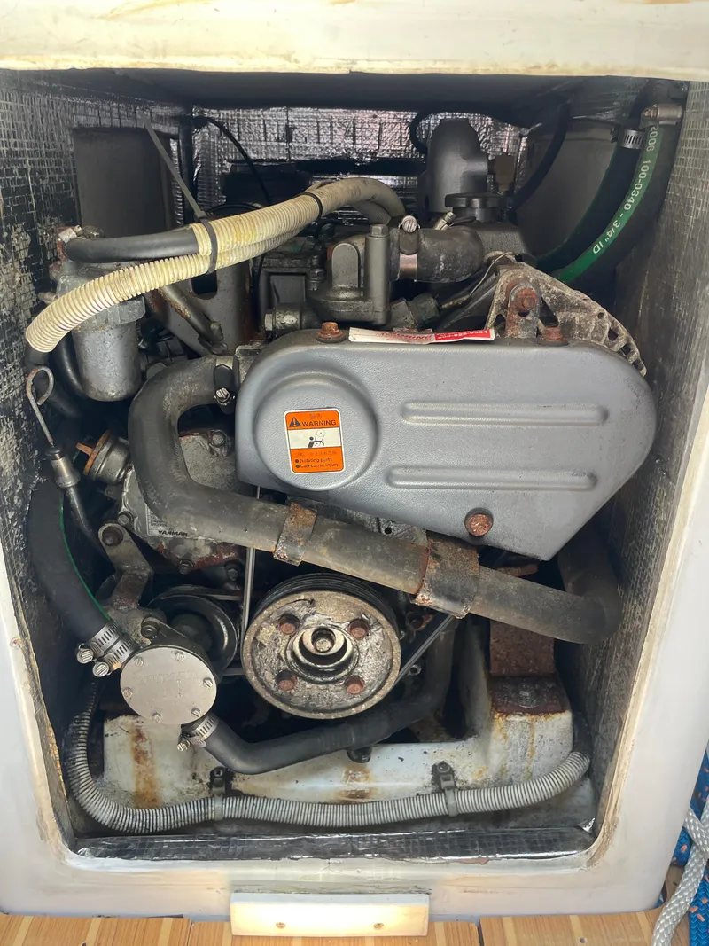 Slide: The Image of Engine compartment of a 2014 J Boats J 88 sailboat, showing mechanical components and hoses. - 17