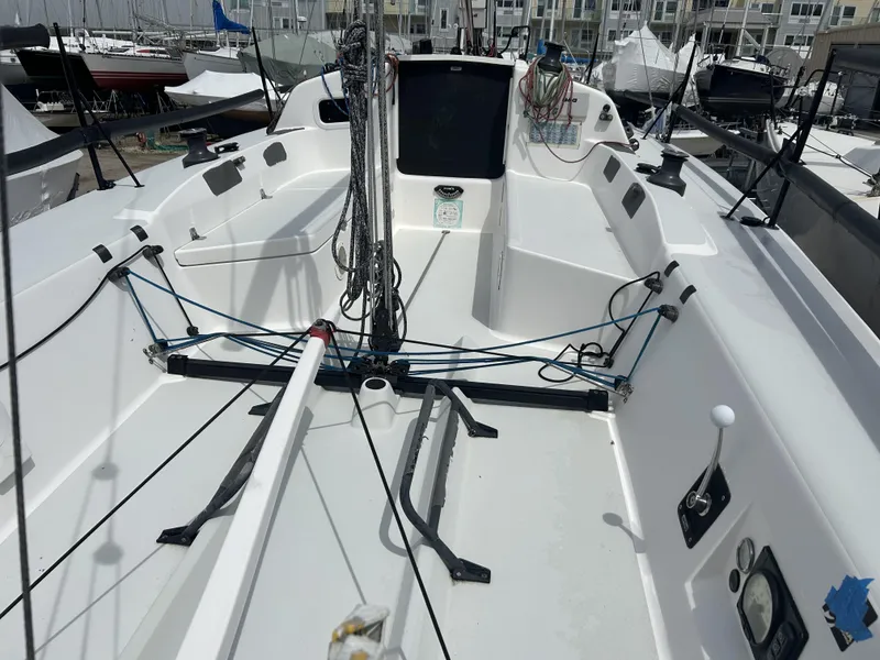 Slide: The Image of 2014 J Boats J 88 sailboat cockpit with rigging and controls, docked in a marina. - 3