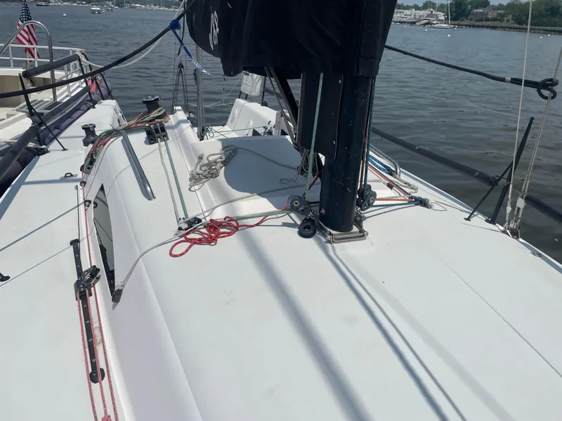 Slide: The Image of 2014 J Boats J 88 sailboat deck with rigging, docked on a calm waterway. - 7