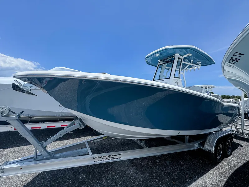 The Image of 2026 Tidewater 232 CC Adventure boat on trailer under clear blue sky. - 0
