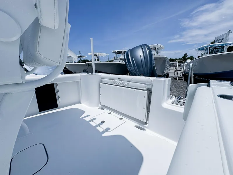 Slide: The Image of 2026 Tidewater 232 CC Adventure boat interior with seating and outboard motor. - 4