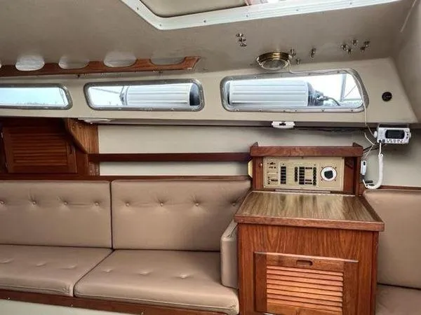 Slide: The Image of Interior of a 1986 Catalina 30 sailboat with beige seating and wooden cabinetry. - 12