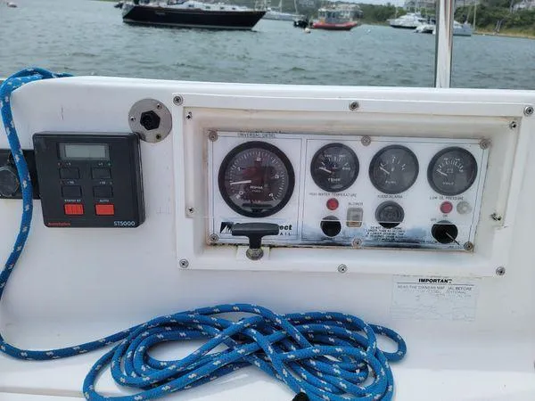 Slide: The Image of Control panel of a 1986 Catalina 30 sailboat with gauges and blue rope. - 19