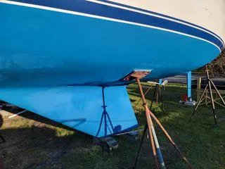 Slide: The Image of 1986 Catalina 30 sailboat hull on stands, blue finish, side view. - 4