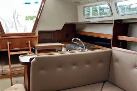 Slide: The Image of 1986 Catalina 30 yacht interior with kitchen and seating area. - 5