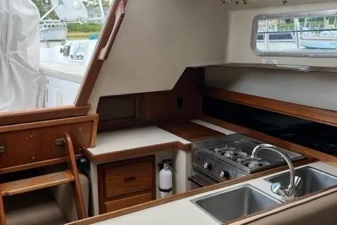 Slide: The Image of Interior of 1986 Catalina 30 sailboat with kitchen, stove, and sink. - 6