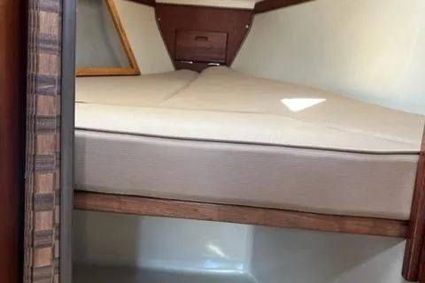 Slide: The Image of Interior cabin of 1986 Catalina 30 sailboat with beige cushions and wooden accents. - 8