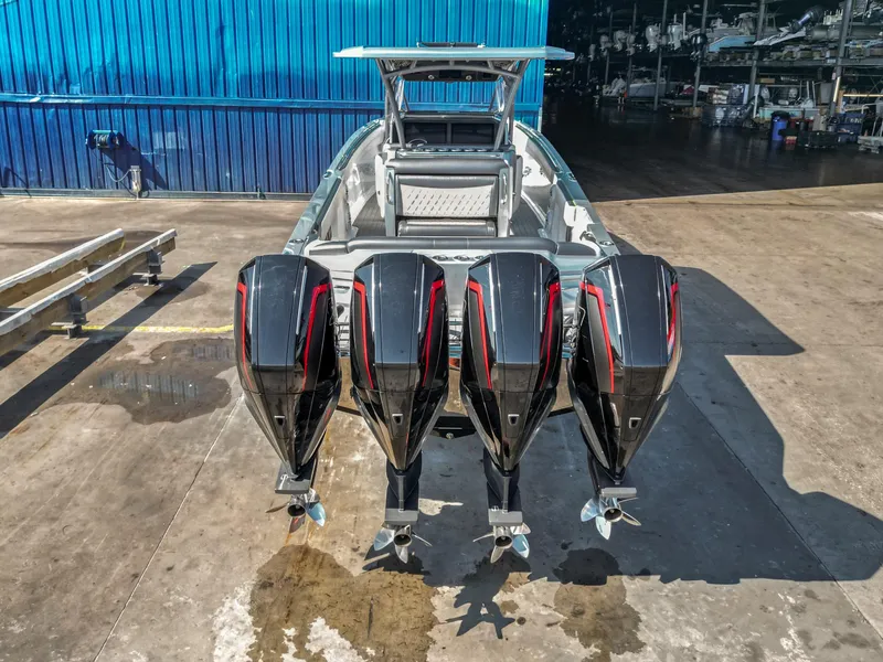 Slide: The Image of 2021 Nor-Tech 390 Sport Center Console with four powerful outboard engines. - 10