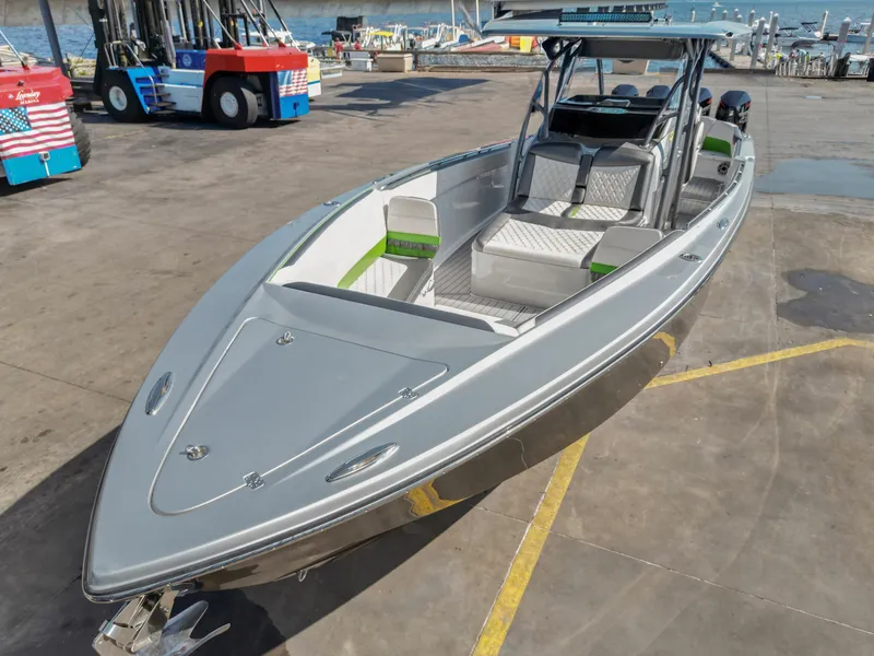 Slide: The Image of 2021 Nor-Tech 390 Sport Center Console boat docked at a marina. - 13