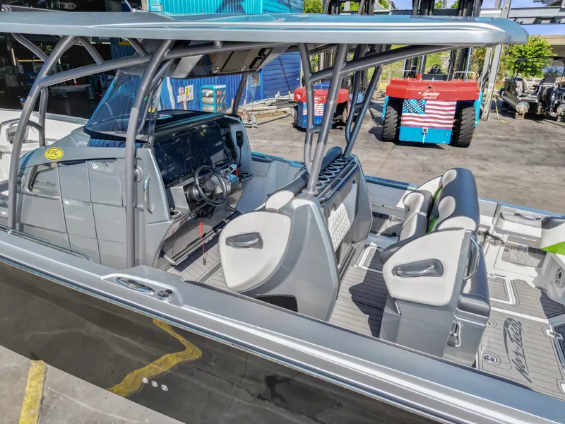 Slide: The Image of 2021 Nor-Tech 390 Sport Center Console boat interior with modern seating and steering console. - 17