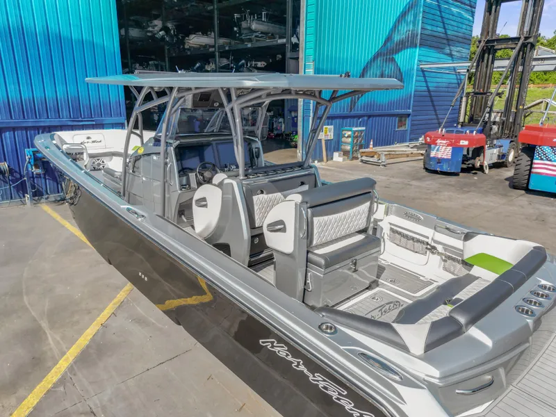 Slide: The Image of 2021 Nor-Tech 390 Sport Center Console boat in a marina setting. - 18