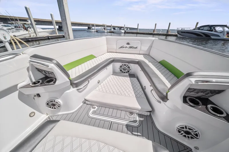 Slide: The Image of 2021 Nor-Tech 390 Sport Center Console boat interior with luxurious seating and cup holders. - 26
