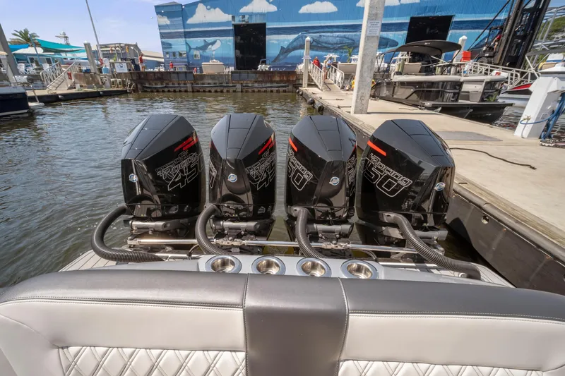 Slide: The Image of 2021 Nor-Tech 390 Sport Center Console with four powerful outboard engines docked at marina. - 34