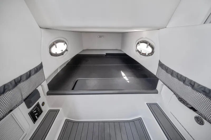 Slide: The Image of Interior cabin of 2021 Nor-Tech 390 Sport Center Console boat, featuring sleek design and portholes. - 38