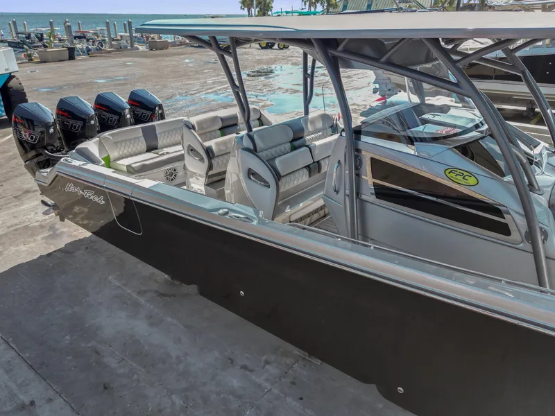 Slide: The Image of 2021 Nor-Tech 390 Sport Center Console boat with quad engines, docked at marina. - 4