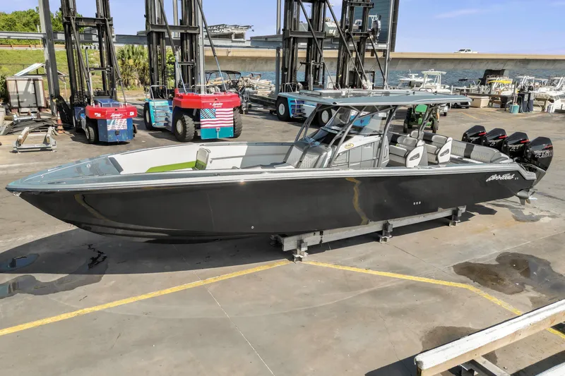 Slide: The Image of 2021 Nor-Tech 390 Sport Center Console boat on a dock, featuring sleek design and powerful engines. - 42