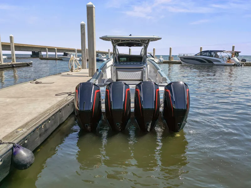 Slide: The Image of 2021 Nor-Tech 390 Sport Center Console with four powerful outboard engines docked at marina. - 5