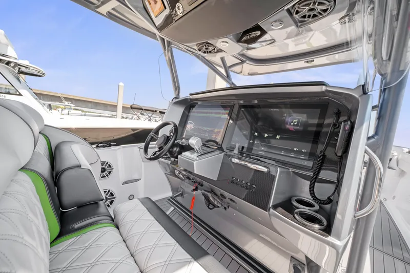 Slide: The Image of 2021 Nor-Tech 390 Sport Center Console interior with modern dashboard and seating. - 8