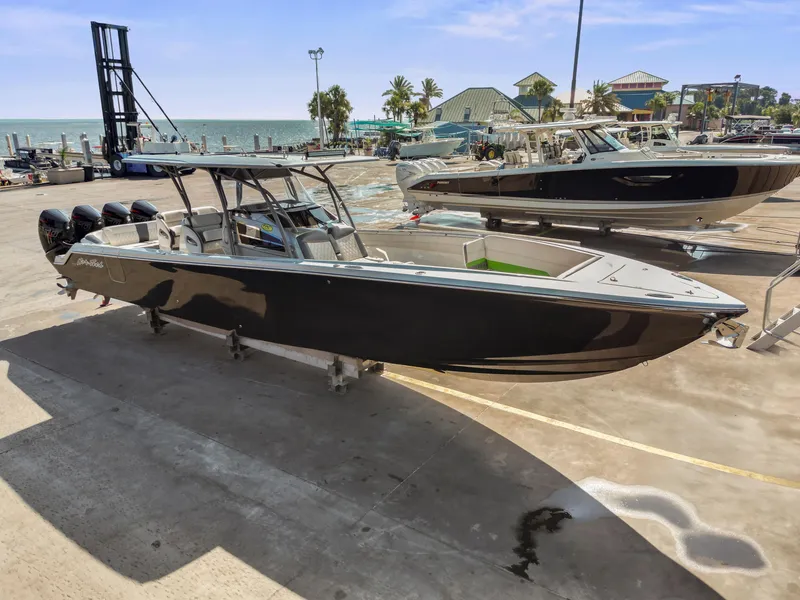 Slide: The Image of 2021 Nor-Tech 390 Sport Center Console boat on dock, ocean in background. - 9
