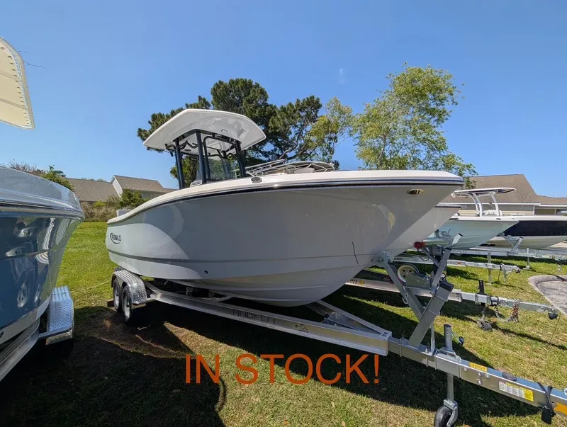 The Image of 2025 Robalo R232 Explorer boat on trailer, in stock, sunny day. - 1
