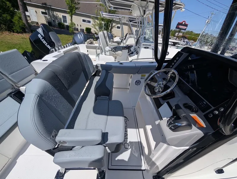 Slide: The Image of 2025 Robalo R232 Explorer boat interior with modern helm and seating. - 10