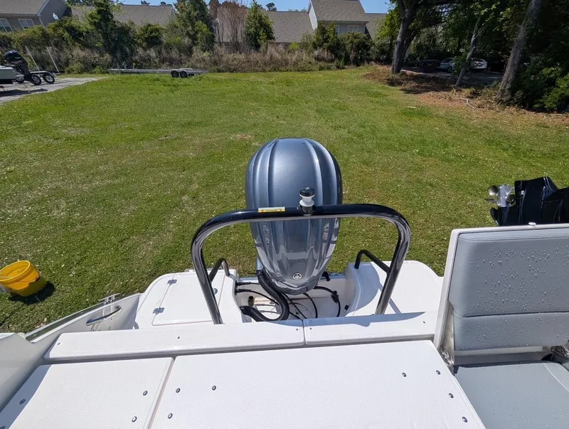 Slide: The Image of 2025 Robalo R232 Explorer boat with outboard motor on grassy area. - 12