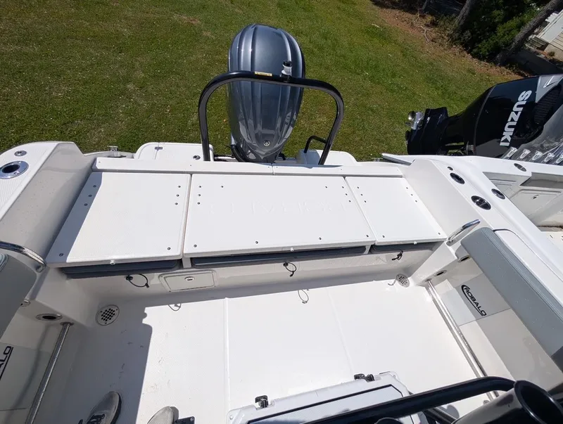 Slide: The Image of 2025 Robalo R232 Explorer boat interior with Suzuki engine, featuring spacious seating and storage. - 15