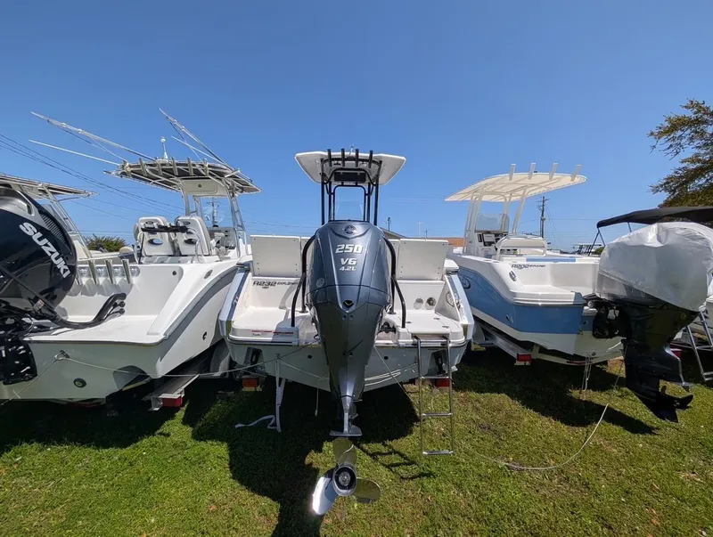 Slide: The Image of 2025 Robalo R232 Explorer boat with powerful outboard motor, displayed outdoors. - 3