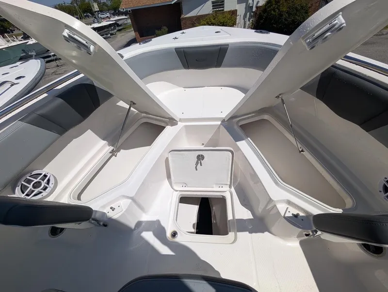 Slide: The Image of 2025 Robalo R232 Explorer boat with open storage compartments and seating area. - 4