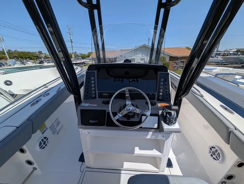 Slide: The Image of 2025 Robalo R232 Explorer boat cockpit with steering wheel and control panel. - 5