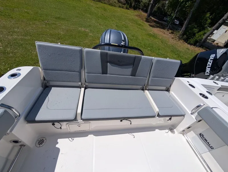 Slide: The Image of 2025 Robalo R232 Explorer boat with gray seating and Suzuki engine. - 7