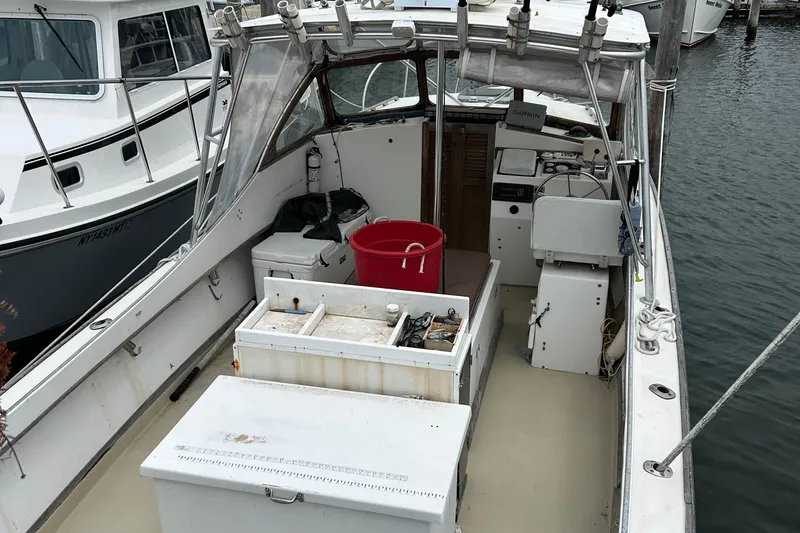 The Image of 1991 Fortier 26 Hard Top boat interior with fishing gear and equipment. - 1