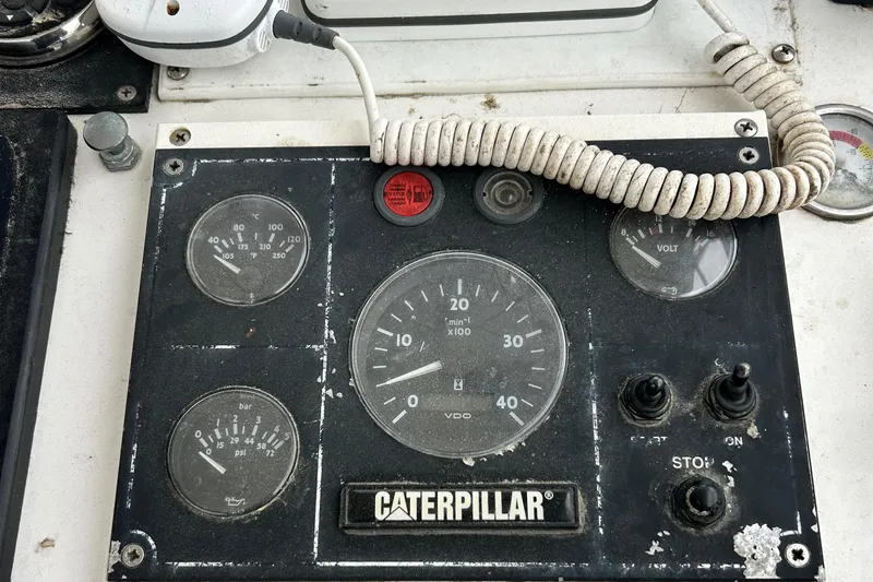 Slide: The Image of Control panel of a 1991 Fortier 26 Hard Top boat with Caterpillar gauges. - 10