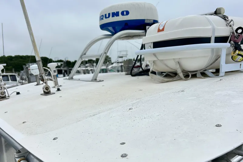 Slide: The Image of 1991 Fortier 26 Hard Top boat deck with radar and life raft. - 5